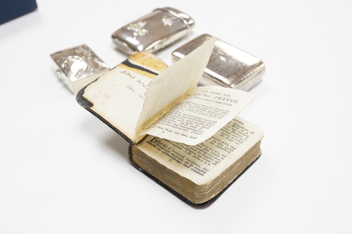 A Japanese white metal and polychrome enamel vesta case, decorated with flowers and butterfly, 56mm, together with a 19th century Russian 84 zolotnik and niello snuff box(tired), a modern silver pill box and a silver mou
